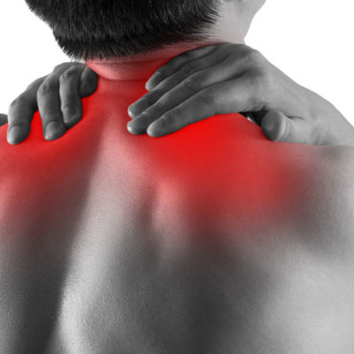 black and white image of man rubbing his upper back, which is colored red to show pain