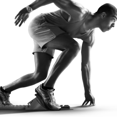 Black and white image of a male athlete running track