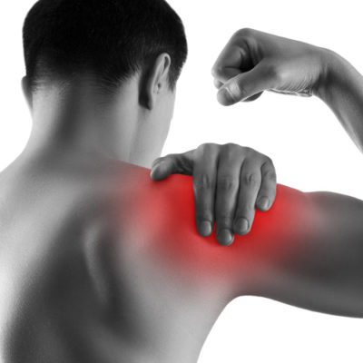 black and white image of man rubbing his shoulder, which is colored red to show pain