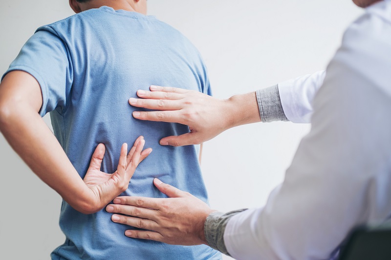 Doctor consulting with patient on back problems